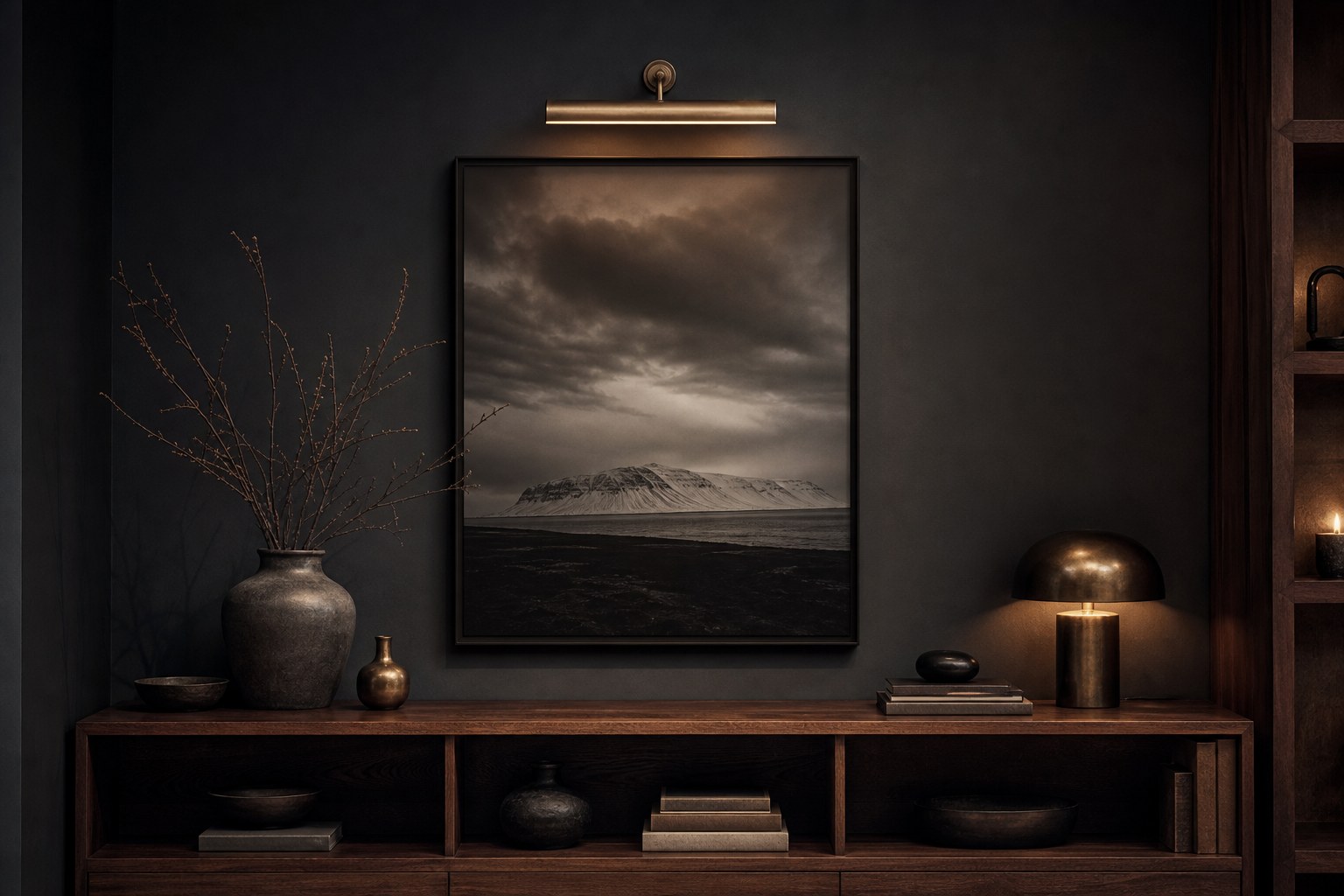 Detail of a charcoal-painted wall in Railings tone meeting a smoked-walnut shelf with a single brass picture light